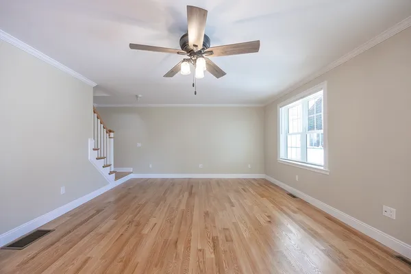 wooden floor in an empty room with a window