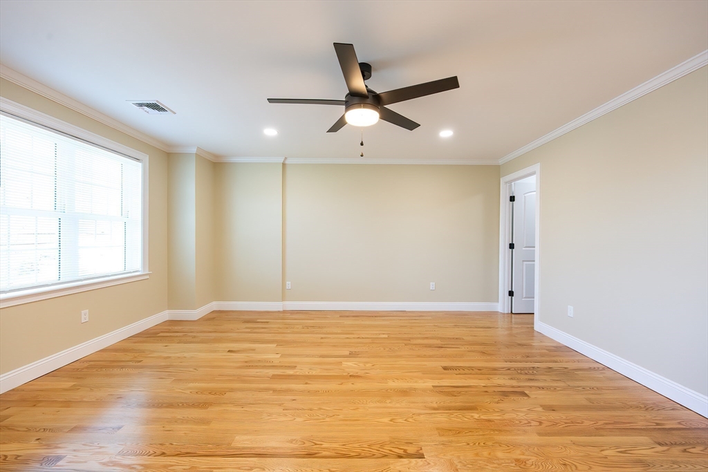 50 Pullman Avenue, Unit B Attleboro, MA 02703 - Photo 16 of 28 a view of an empty room with wooden floor and a window
