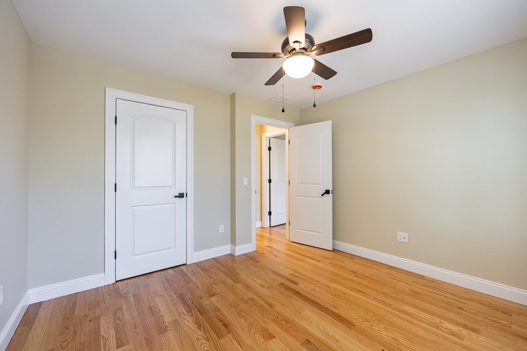 50 Pullman Avenue, Unit B Attleboro, MA 02703 - Photo 22 of 28 an empty room with wooden floor and ceiling fan