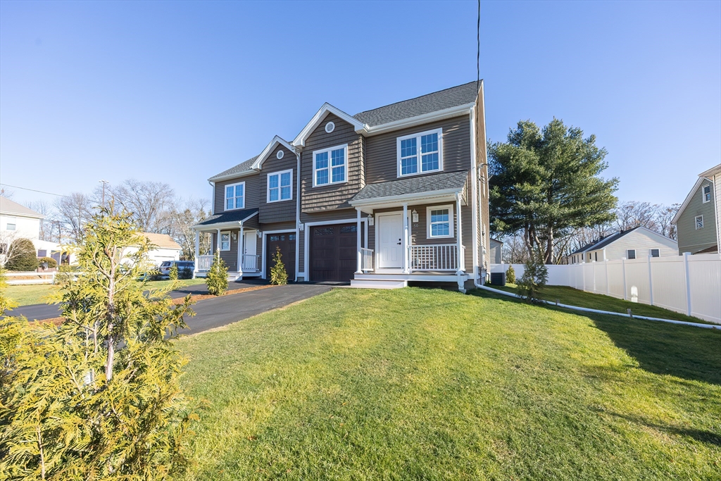 50 Pullman Avenue, Unit B Attleboro, MA 02703 - Photo 28 of 28 a front view of a house with a garden and yard