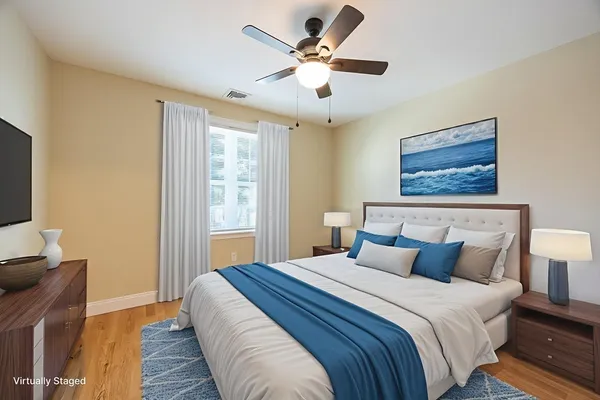a bedroom with a large bed and a window
