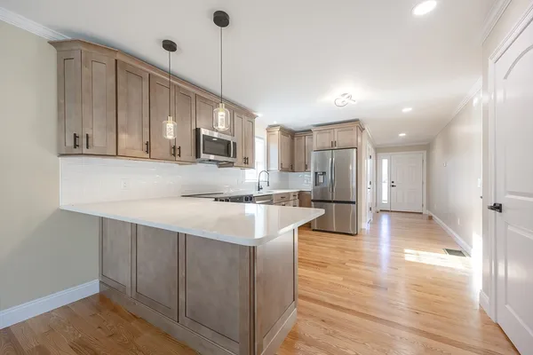 a kitchen with kitchen island white cabinets and stainless steel appliances