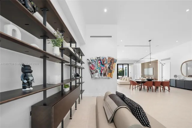 a living room with furniture kitchen view and a large window