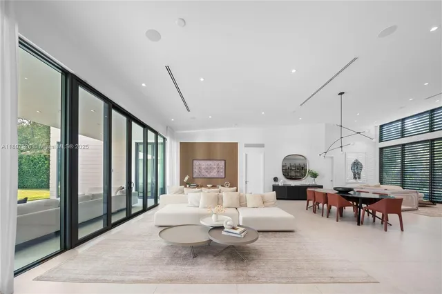 a living room with furniture and painting on the wall