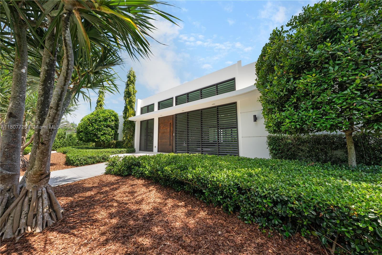 9450 Southwest 98th Street Miami, FL 33176 - Photo 3 of 66 a front view of a house with a garden