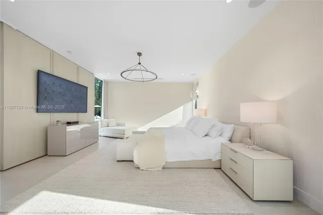 a bedroom with furniture and a chandelier