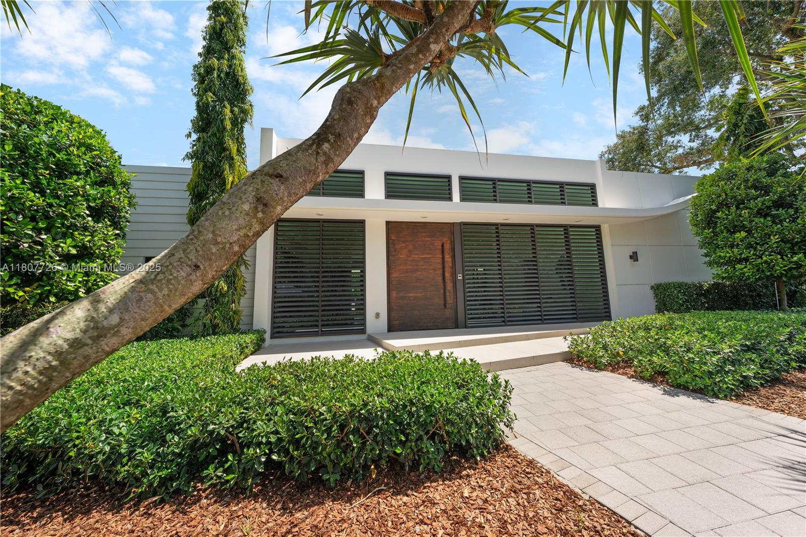 9450 Southwest 98th Street Miami, FL 33176 - Photo 5 of 66 a front view of a house with a yard and garage