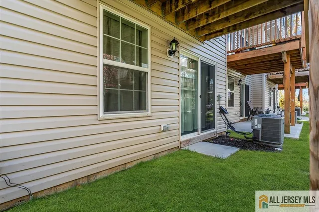 a view of backyard with a deck and a garden