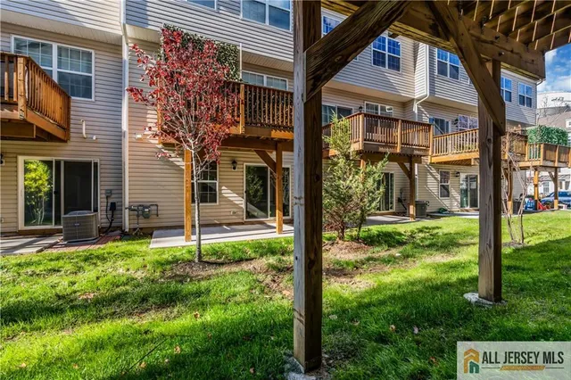 a view of a house with backyard and a tree