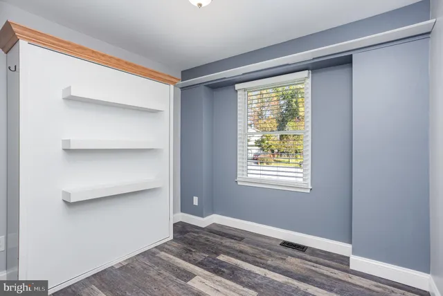 a bathroom with a granite countertop sink a toilet and a bathtub