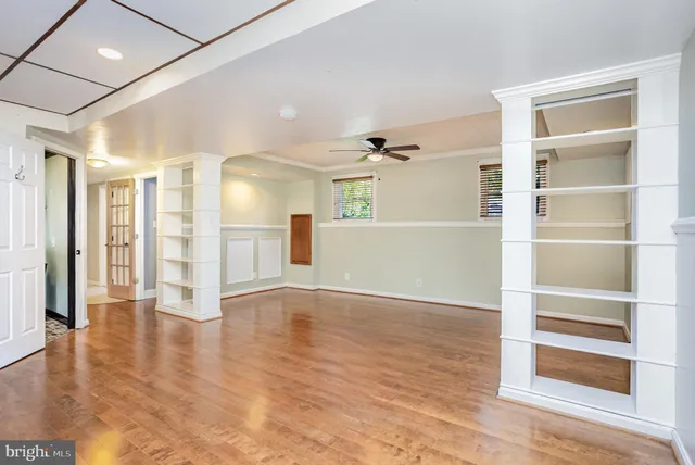 a view of room with window and wooden floor