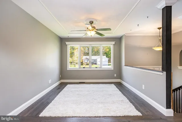 a kitchen with stainless steel appliances kitchen island granite countertop a refrigerator and cabinets