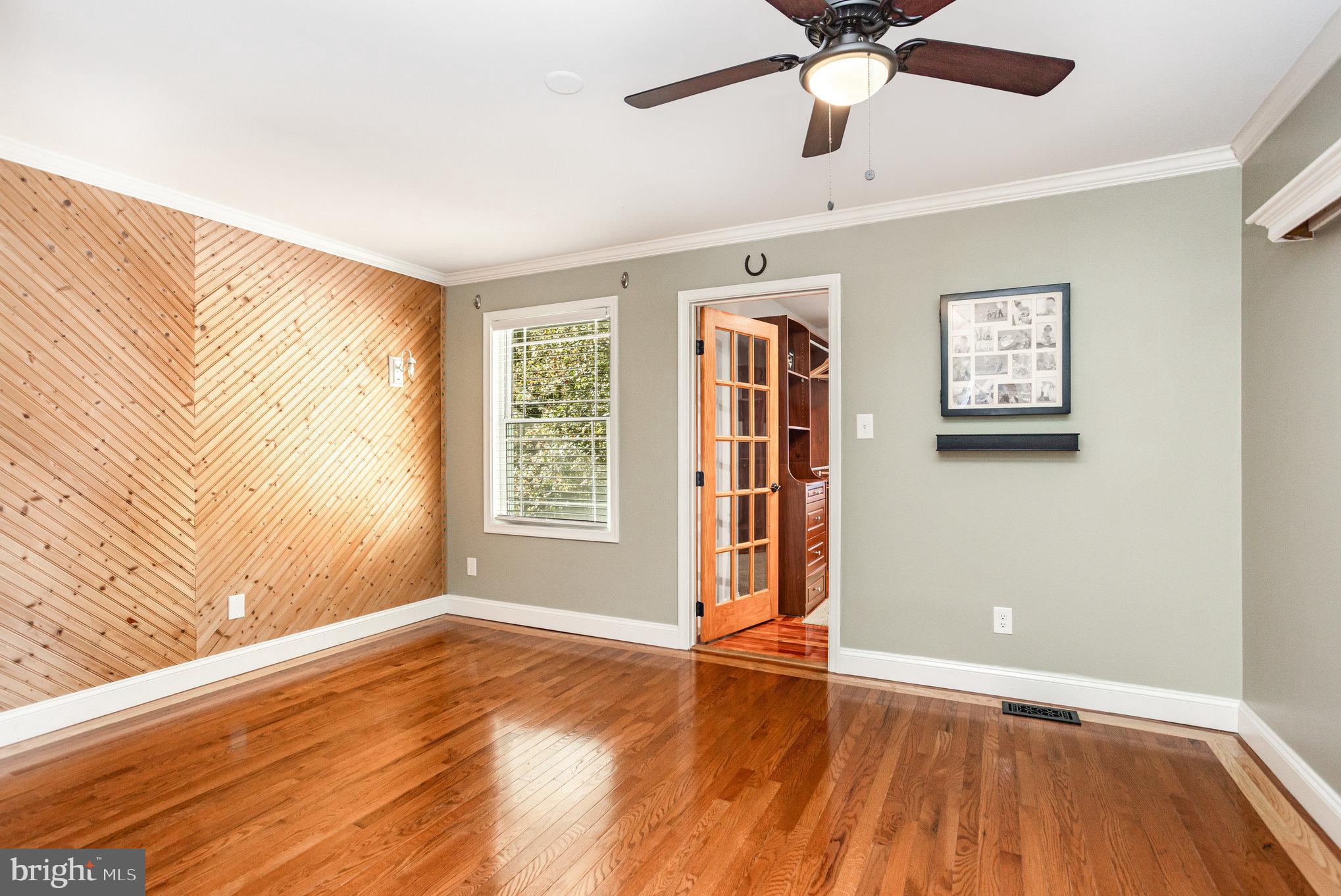5 Kings Court Elkton, MD 21921 - Photo 8 of 34 an empty room with wooden floor chandelier fan and windows