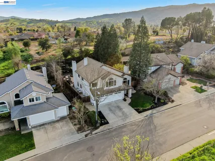 an aerial view of a house with a yard