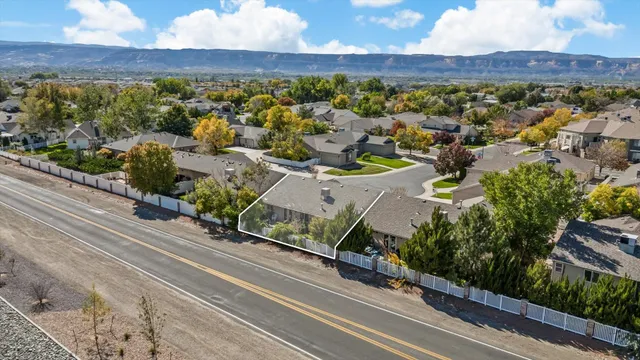 a view of a chair and table in backyard of the house