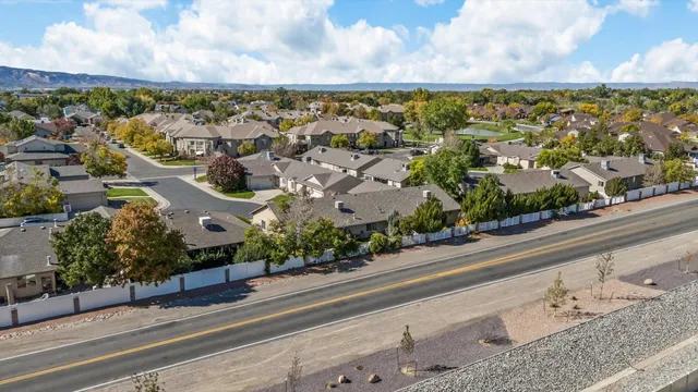 an aerial view of a house with swimming pool and furniture