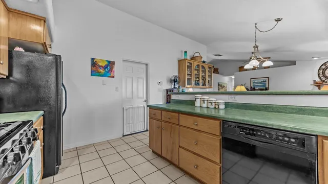 a kitchen with stainless steel appliances granite countertop a refrigerator and a stove