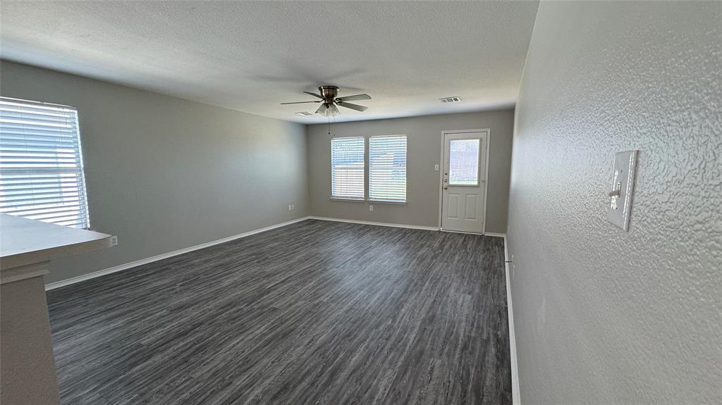 907 Post Oak Trail Anna, TX 75409 - Photo 14 of 31 a view of empty room with wooden floor and fan