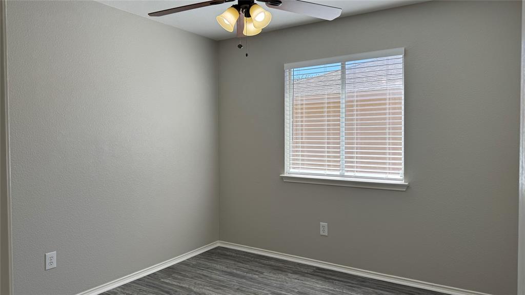 907 Post Oak Trail Anna, TX 75409 - Photo 20 of 31 a view of an empty room with wooden floor and a window