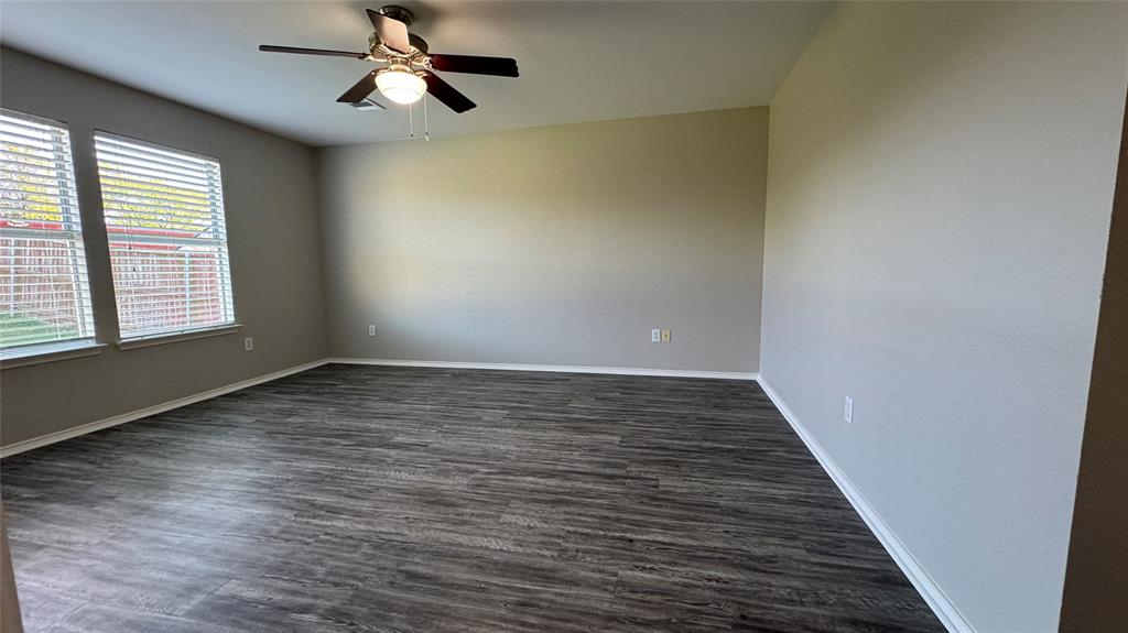 907 Post Oak Trail Anna, TX 75409 - Photo 24 of 31 an empty room with wooden floor fan and windows