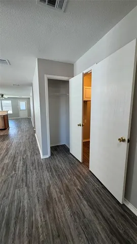 a view of a room with wooden floor and a sink