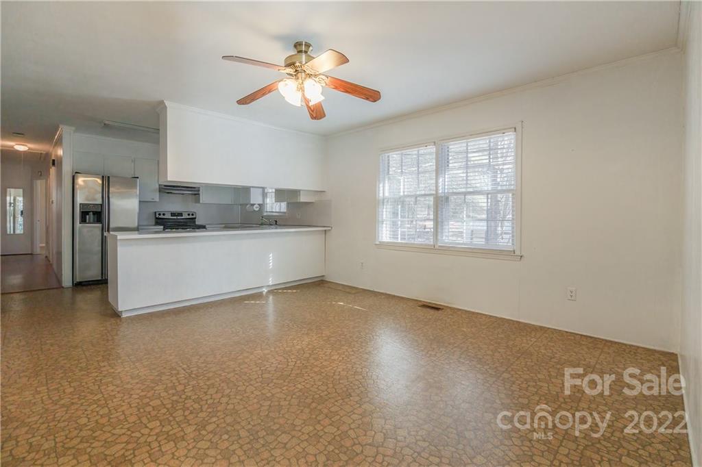 2070 John Everall Road Lancaster, SC 29720 - Photo 11 of 27 an empty room with chandelier fan and windows