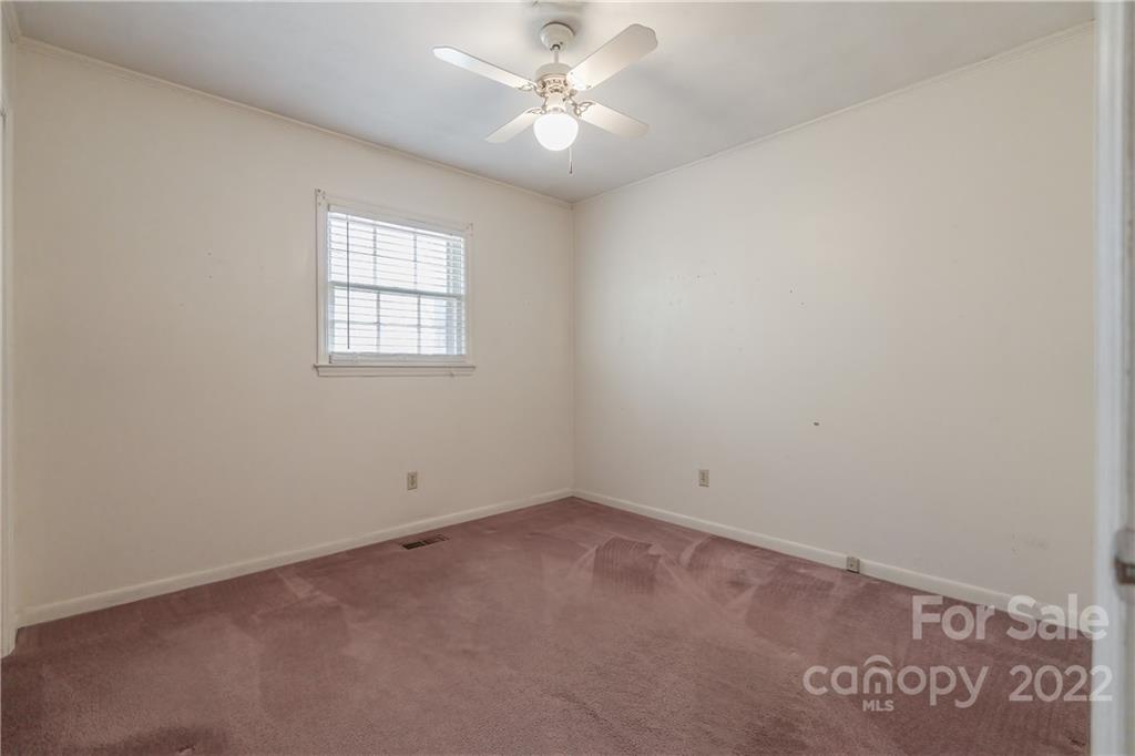 2070 John Everall Road Lancaster, SC 29720 - Photo 17 of 27 an empty room with a window and a ceiling fan