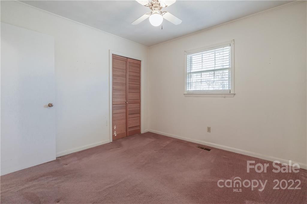 2070 John Everall Road Lancaster, SC 29720 - Photo 18 of 27 an empty room with chandelier fan and windows
