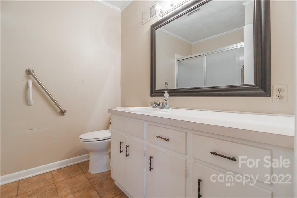 2070 John Everall Road Lancaster, SC 29720 - Photo 21 of 27 a bathroom with a sink a toilet and a mirror