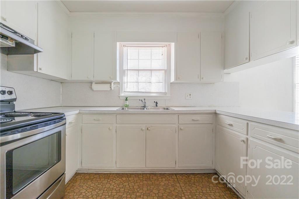 2070 John Everall Road Lancaster, SC 29720 - Photo 9 of 27 a kitchen with granite countertop white cabinets and white appliances