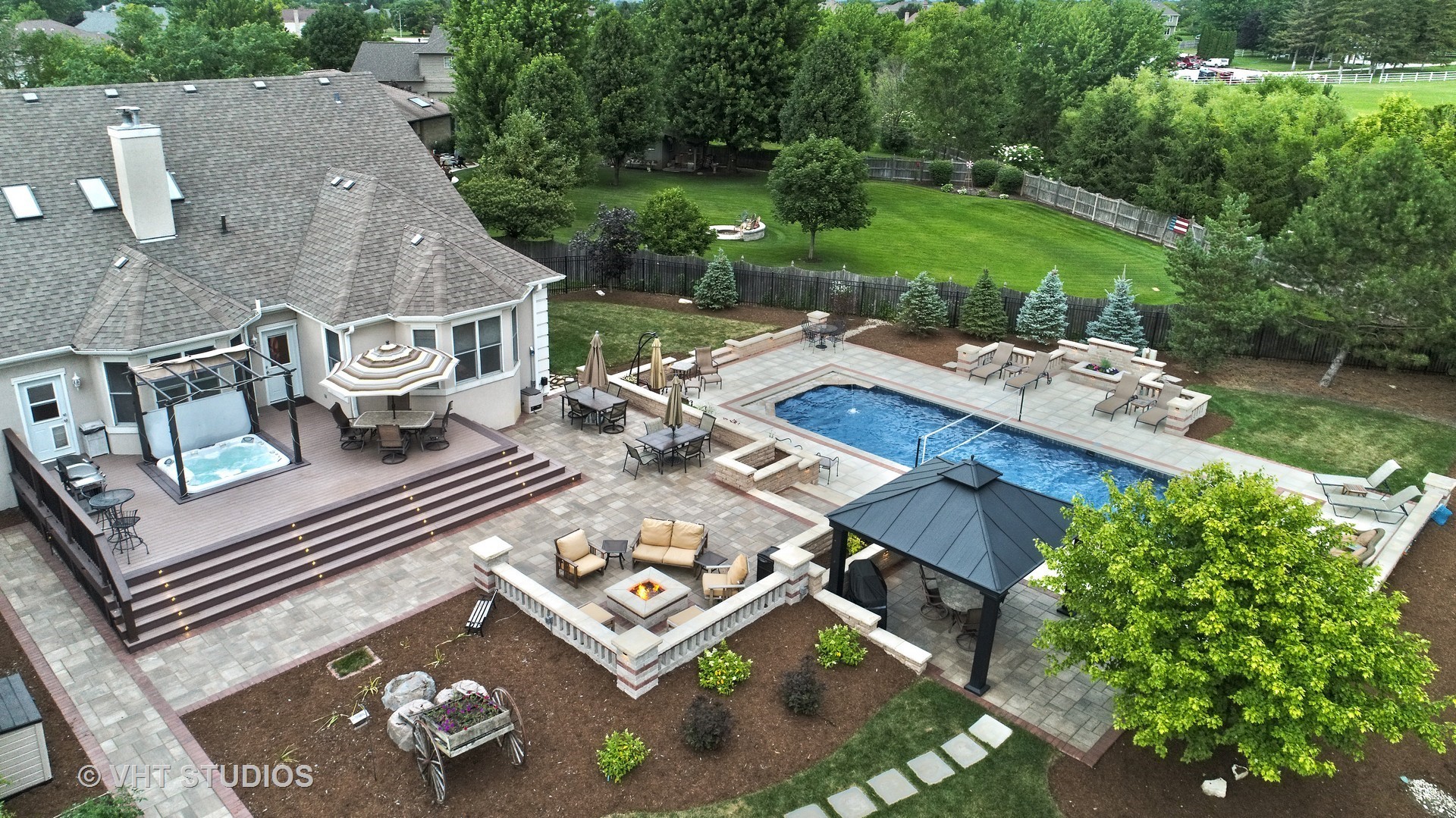 an aerial view of a house with garden space and patio