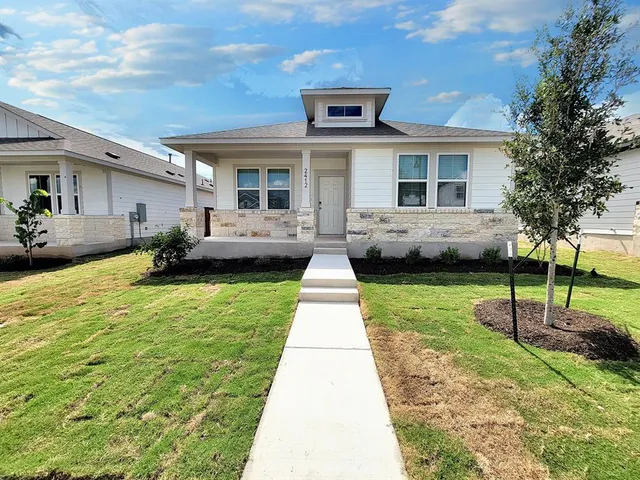 a front view of a house with a garden and patio
