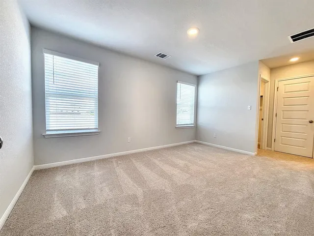 a bathroom with a granite countertop bathtub and a toilet