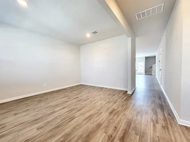 a view of a kitchen with a sink and a refrigerator