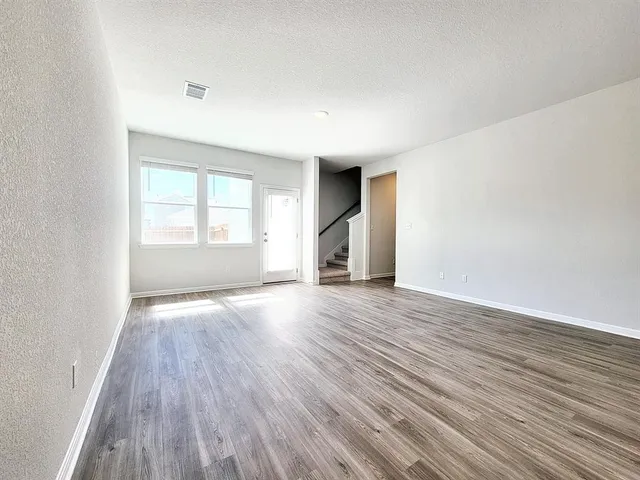 a view of a room with wooden floor