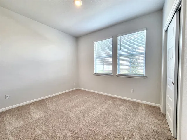 a bathroom with a granite countertop sink a toilet and shower
