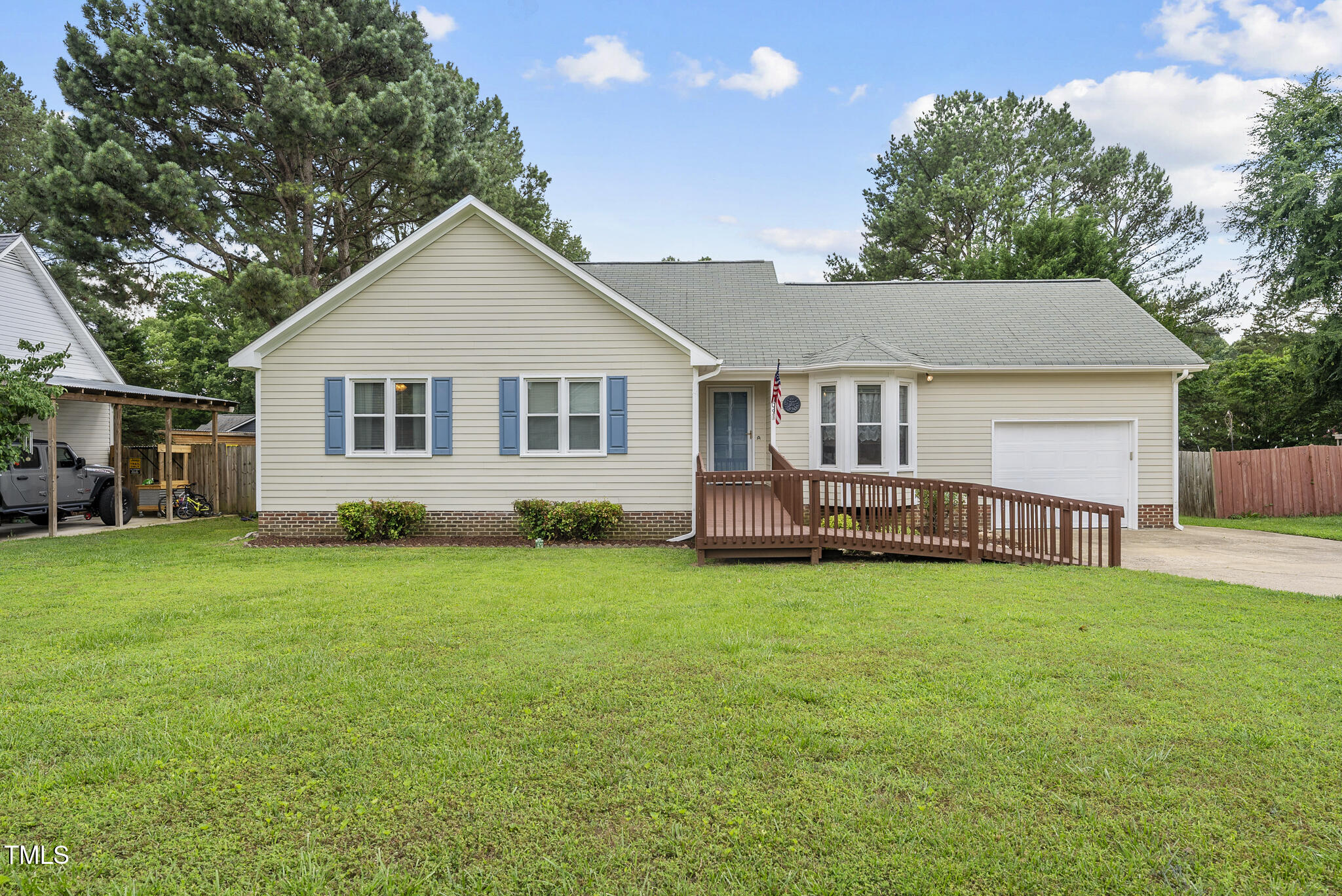 a view of a house with a yard and deck