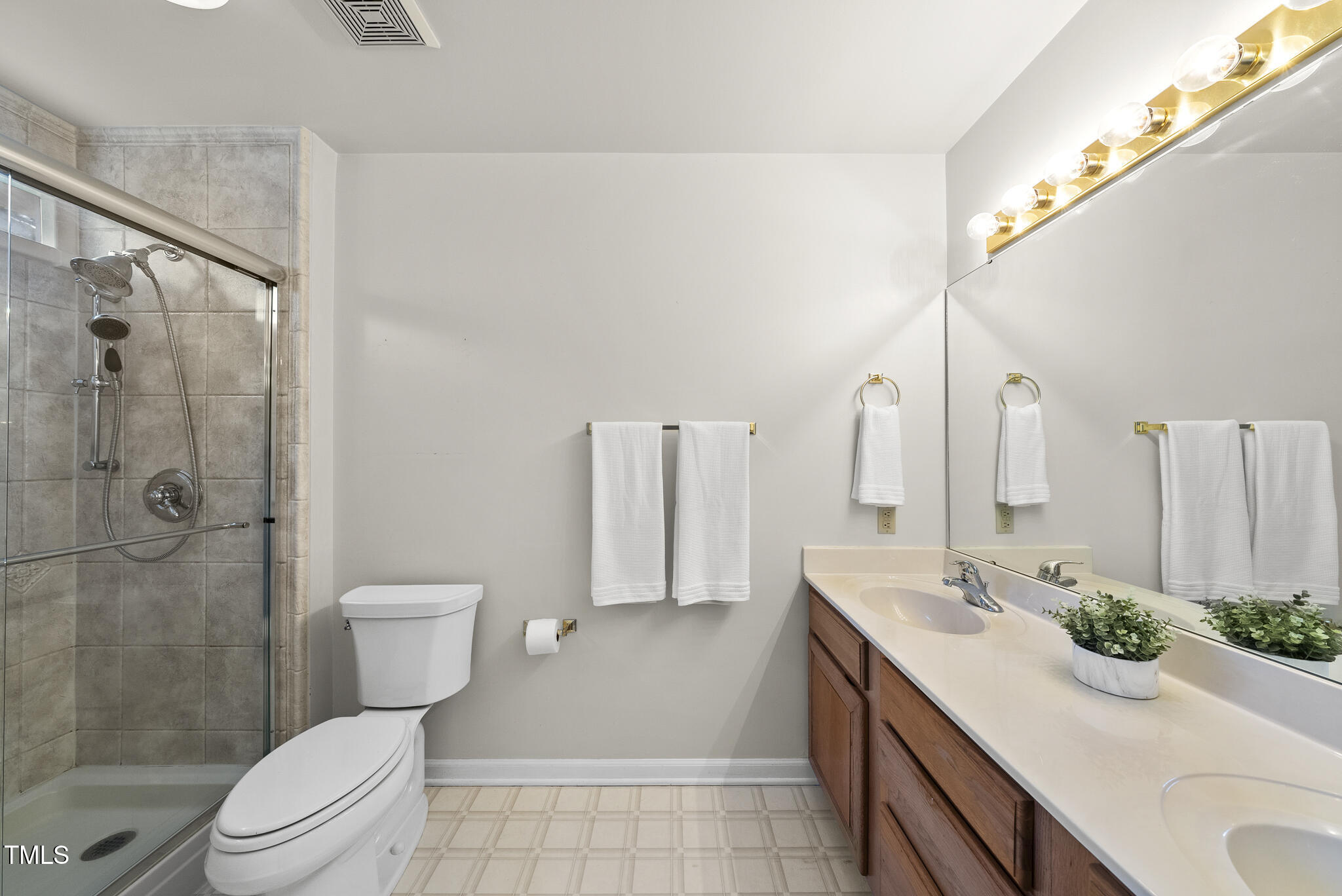1609 Forest Road Wake Forest, NC 27587 - Photo 12 of 22 a bathroom with a sink a toilet and shower