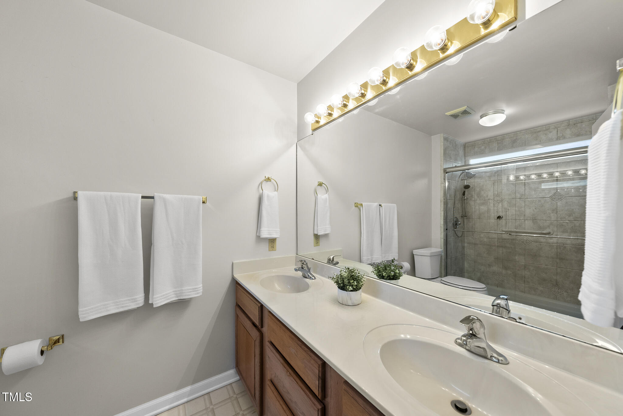 1609 Forest Road Wake Forest, NC 27587 - Photo 13 of 22 a bathroom with a sink and a mirror