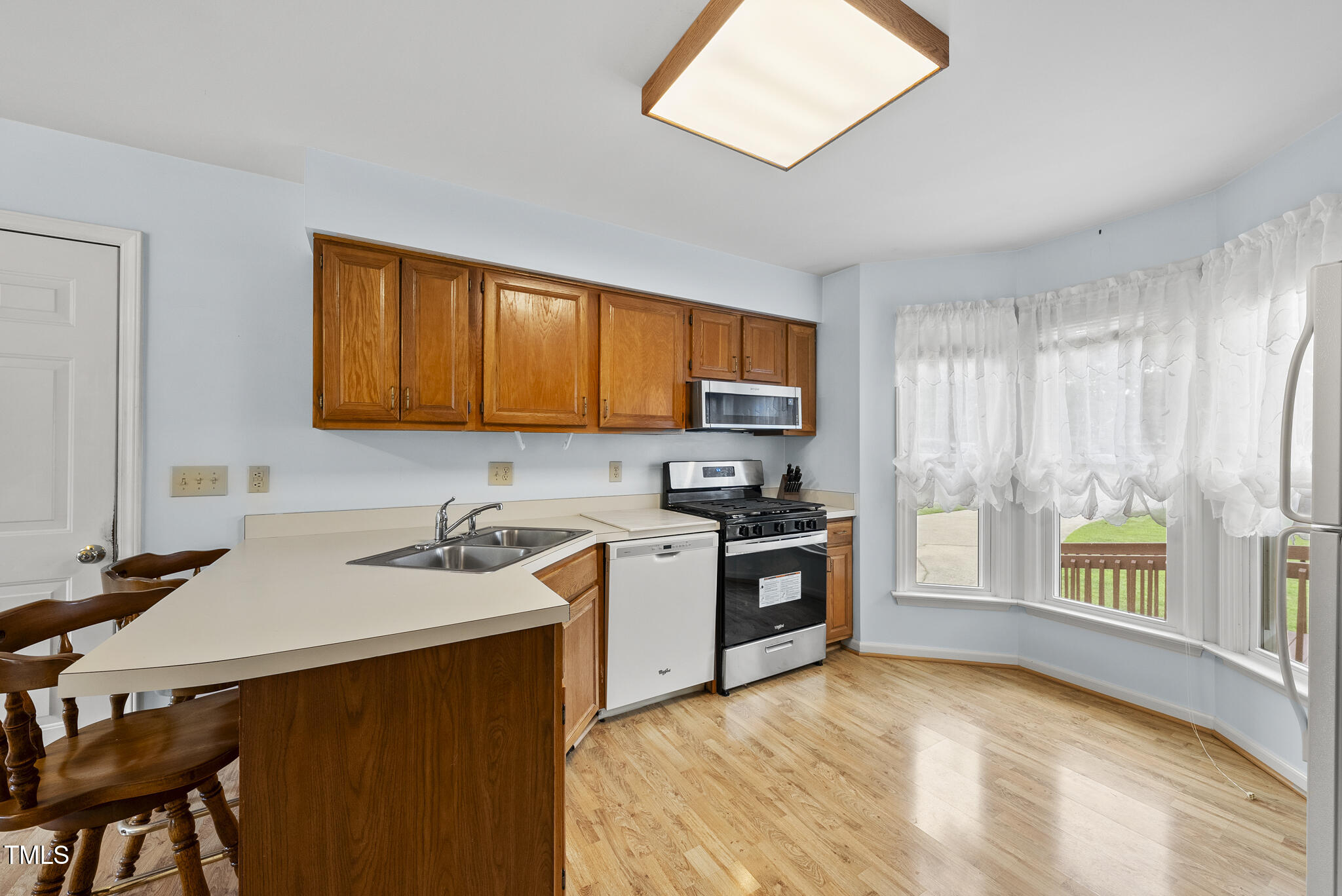 1609 Forest Road Wake Forest, NC 27587 - Photo 6 of 22 a kitchen with a stove a sink a refrigerator and a window