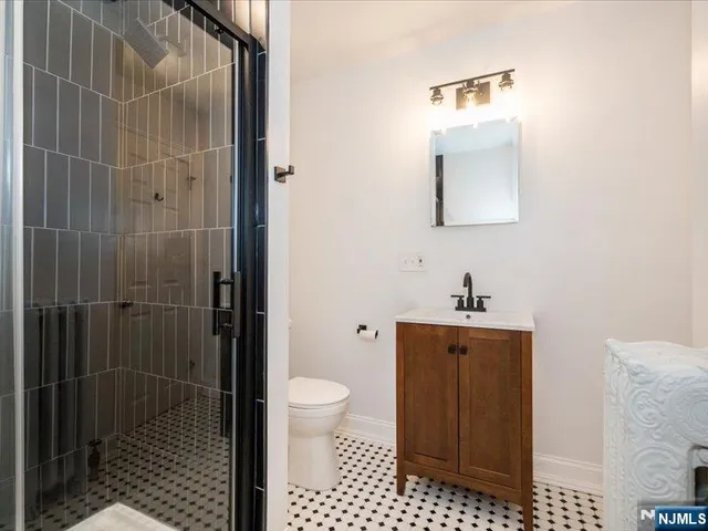 a bathroom with a toilet a sink and shower