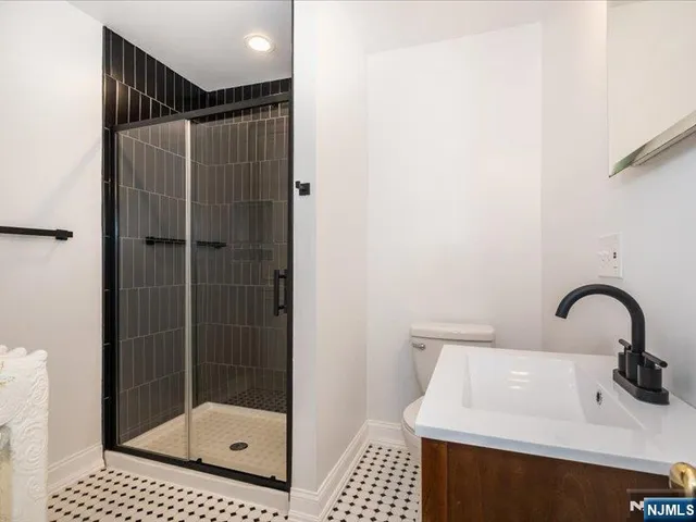 a bathroom with a shower and a sink
