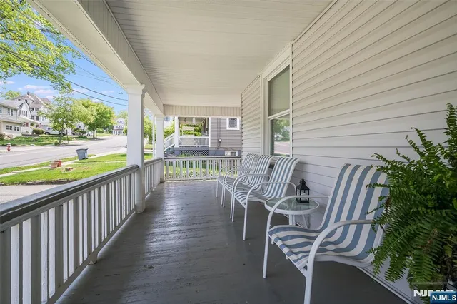 a view of balcony with two chairs and table in patio