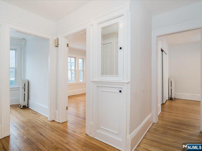 14 Ravine Avenue, Unit 2 Caldwell, NJ 07006 - Photo 5 of 23 a view of hallway with wooden floor and stairs