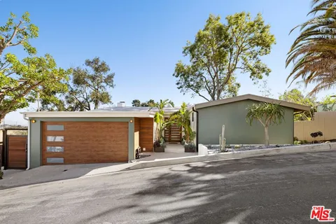 a view of a house with a yard and garage