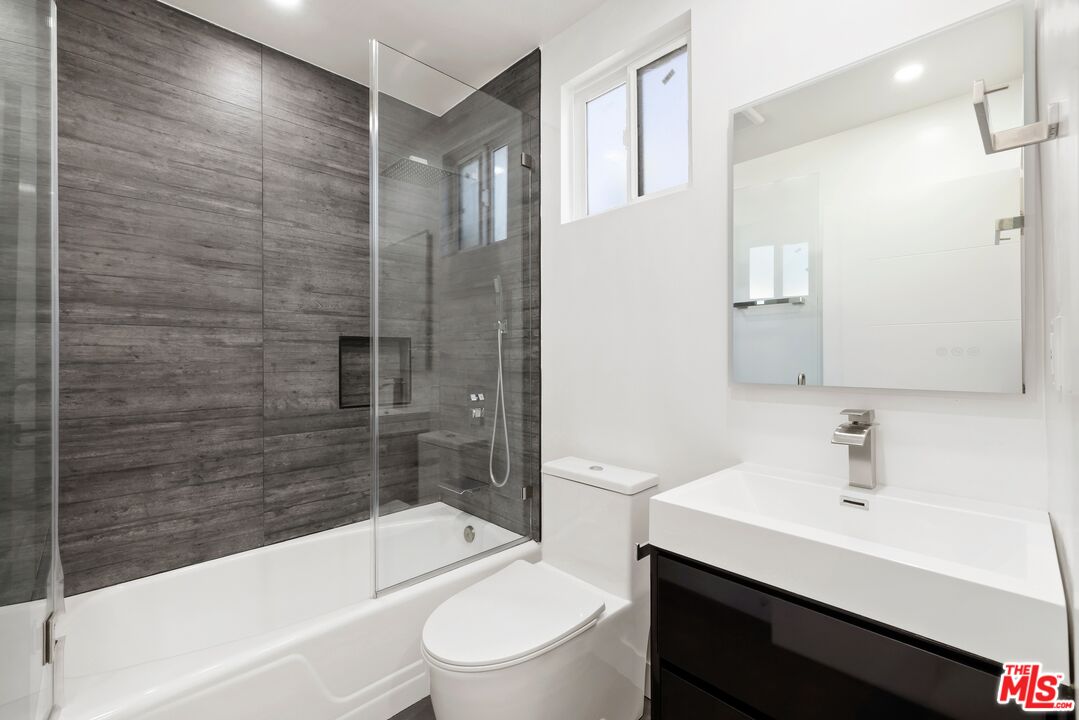 2204 Ridgemont Drive Los Angeles, CA 90046 - Photo 11 of 13 a bathroom with a bathtub shower sink vanity and toilet