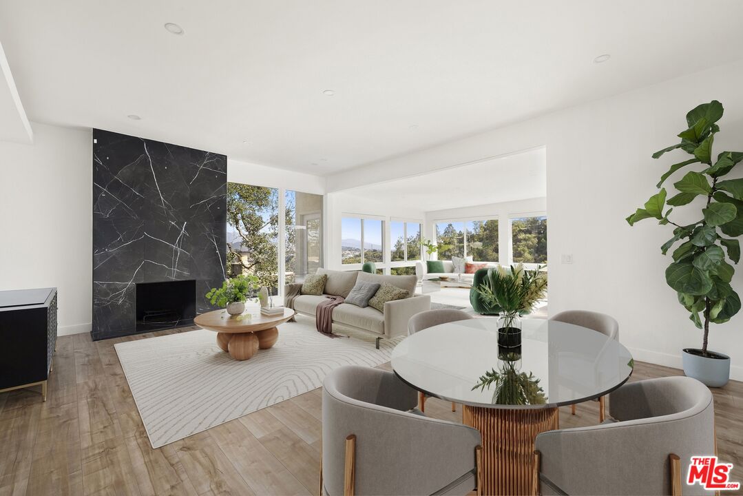 2204 Ridgemont Drive Los Angeles, CA 90046 - Photo 5 of 13 a living room with furniture potted plant and a fireplace