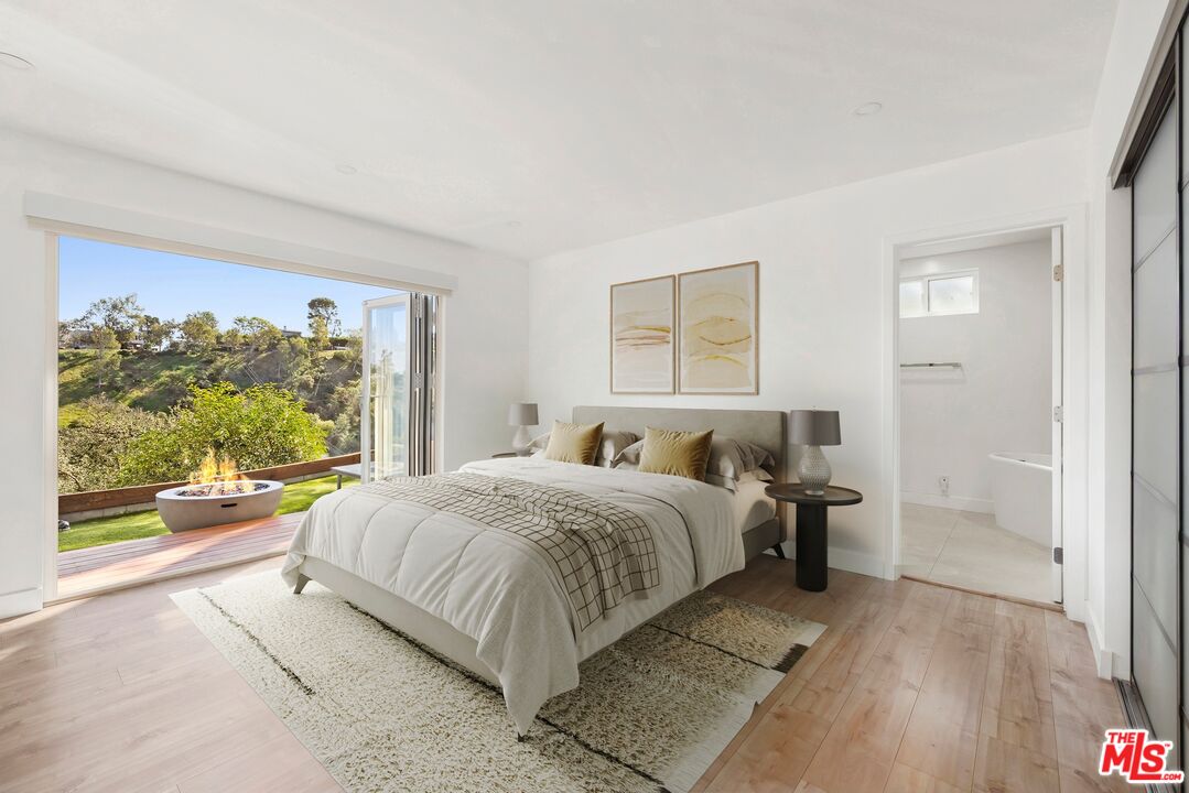 2204 Ridgemont Drive Los Angeles, CA 90046 - Photo 7 of 13 a bedroom with a bed and a large window