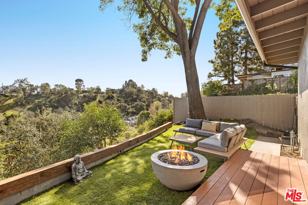 2204 Ridgemont Drive Los Angeles, CA 90046 - Photo 8 of 13 a view of a balcony with two chairs and a potted plant