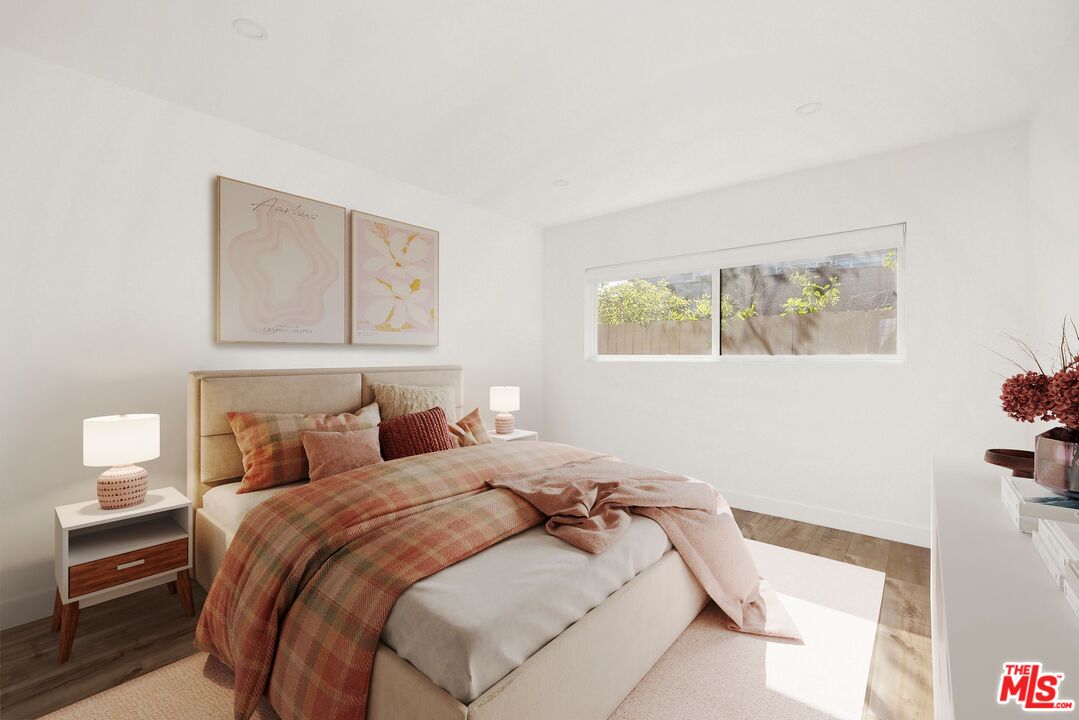 2204 Ridgemont Drive Los Angeles, CA 90046 - Photo 10 of 13 a bedroom with a bed and a painting on the wall